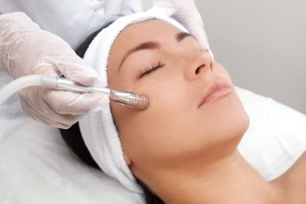 The Cosmetologist Makes The Procedure Microdermabrasion Of The Facial Skin